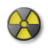 A circular icon with a gray background and three yellow triangular radiation symbols arranged in a pinwheel pattern.