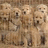 Pixelated group of light brown figures with dark eyes and mouths on a brown background, next to black with white text 'group huggg!!'