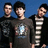 Three people stand against a blue background with pixelated text overlays on black and gray
