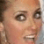 four identical pixelated images showing a person with light brown hair pulled back, wearing large hoop earrings and a neutral expression