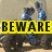 A pixelated image shows two figures in blue and gray clothing standing behind a yellow banner with black text reading BEWARE.