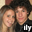 Two people with dark hair pose closely together in a pixelated image; one wears black clothing and the other has light-colored hair, with white text 'ily' visible at bottom right.