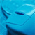 Pixelated blue-toned image showing a stylized face with closed eyes, a curved smile, and a single dark line on the left side resembling a hair or ear shape.