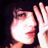 Pixelated close-up of a person's face with hand near mouth, dark background, and visible dithering artifacts.