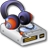 Pixelated image of a silver USB flash drive with orange and blue accents, positioned next to purple headphones on a white background.