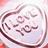 A circular icon with a light purple background and dark brown border containing stylized text in a cursive font.