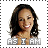 Pixelated portrait of a smiling person with long dark hair, wearing a light-colored top, with text below reading 'AS I AM' in blocky letters.