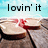 A pixelated image shows a hand holding a wine glass with red liquid against a light background, with the text 'lovin' it' above.