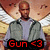 Pixelated image of a person in gray jacket over light shirt with red text 'Gun <3' at bottom, against blurred background.