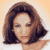 Static pixelated image of a person with shoulder-length brown hair against a light orange background, rendered in low-resolution style typical of early internet buddy icons.