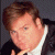 A 50x50 pixel buddy icon split into two frames showing a person in formal attire on the left and green text logo on the right, with visible pixelation and dithering effects.