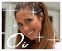 A pixelated portrait of a smiling person with long brown hair, framed by white and pink borders with plus signs and stylized 'Oa' text.