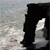 A static pixelated image shows a black silhouette with a white curved shape against a gray gradient background.
