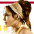 Pixelated profile view of a person with brown hair styled in an updo, wearing a light-colored headband and a yellow garment with white accents.