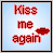 Pixelated red text 'Kiss me again' with a red lips icon on light blue background, bordered by gray and black.