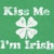 Green background with repeated 'Kiss Me I'm Irish' text and white four-leaf clovers, featuring animated text overlays and a smiling face icon.