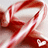 Red and white abstract swirling pattern with smooth gradients on a light gray background.