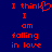 Red pixelated text on dark blue background reads "I think I am falling in love" with a heart symbol replacing the 'o' in 'think'.