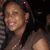 Pixelated static image of a person with dark hair and light skin, wearing a dark top against a blurred background.