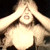 A woman with blonde hair in various poses: hands over face, open mouth shouting, and arms crossed, wearing a black spaghetti-strap top against dark backgrounds.