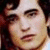 Pixelated close-up of a person's face with dark hair, light skin tone, and visible facial features including eyes, nose, mouth, and part of the forehead.