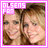 Pixelated image of two people with light brown hair, smiling faces, and a pink border containing partial text.