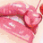 Four distinct close-up views of lips with glossy or glittery textures in pink and red tones, arranged in a