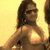 Pixelated image of a person with long dark hair wearing a sleeveless top, set against a light yellow background.