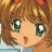 Pixelated close-up of a character with brown hair, green eyes, and a small red mark on the cheek, wearing a light blue garment.