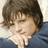 Pixelated image of a person with brown hair resting hand on chin, next to pink text reading 'Josh hutcherson is really HOT! <333' on black background.