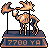 Pixel art of a camel-like creature with orange and brown tones standing on a blue base with '7700 YEN' text, holding a flagpole with a flame-like flag.