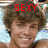 A pixelated image of a person with curly brown hair, smiling, with red text above the head reading SEXY on the left and BEAST!!! on the right.