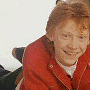 animated frames showing characters in red and black jackets with green text overlays changing across the sequence