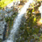 Two identical waterfall images side-by-side above three black letters with red outlines on white backgrounds.