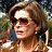 A 48x48 pixel animated contact sheet showing two frames: a woman with sunglasses and curly hair on the left, and a red mailbox with "ARRESTED DEVELOPMENT" text above it on the right.
