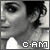 A four- shows a person's face with a white top, displaying pixelated text 'C·AM' and a white crosshair overlay that changes position