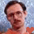 A static image with a red background featuring repeated text phrases and a small photo of a person in the top-left corner.