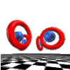 Red torus rings and blue spheres rotate on a checkered floor against a gray background, forming dynamic 3D shapes