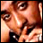 A 2x2 contact sheet of a static image featuring Tupac Shakur's face, his name in script font, and the years 1971-1996 on separate panels with gray backgrounds.