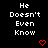 Black background with white pixelated text "He Doesn't Even Know" repeated in a , each instance accompanied by a red pixelated heart below it