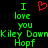 Green pixelated text "I love you Kiley Down Hopf" with a red heart symbol on black background, displayed in two identical side-by-side