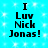 Pixelated text on a bright cyan background with white sparkles, reading "I Luv Nick Jonas!" in four identical arrangements.