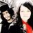 Two people pose together against a red background with white text reading "WHITE STRIPES" in pixelated font.