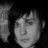 Static grayscale buddy icon showing a pixelated close-up of a person's face with dark hair against a black background, rendered in low-resolution 256x256 pixels.