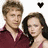 Two people in maroon clothing stand side-by-side with a black heart symbol above them, transitioning to a pink-toned background with blurred figures.