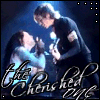 Animated sequence of two figures in dark clothing performing on a blue-lit stage with 'the Cheshire eye' text overlay.