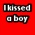 Red background with white text reading "I kissed a boy" and "just to start shit!" above a person in purple hoodie, camouflage cap, and green shirt.