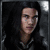 Pixelated image of a person with dark hair in a dimly lit setting, with cyan text overlay reading "Does my being half naked bother you" and a small arrow symbol.