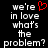 Black background with white pixelated text reading 'we're in love what's the problem?' and a red heart symbol replacing the word 'in' on the left side.