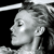 Pixelated grayscale profile of a person with light hair, facing left, against a black background with a white horizontal bar at the top.
